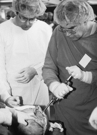 Here, surgeons practice craniotomies on a cadaver.